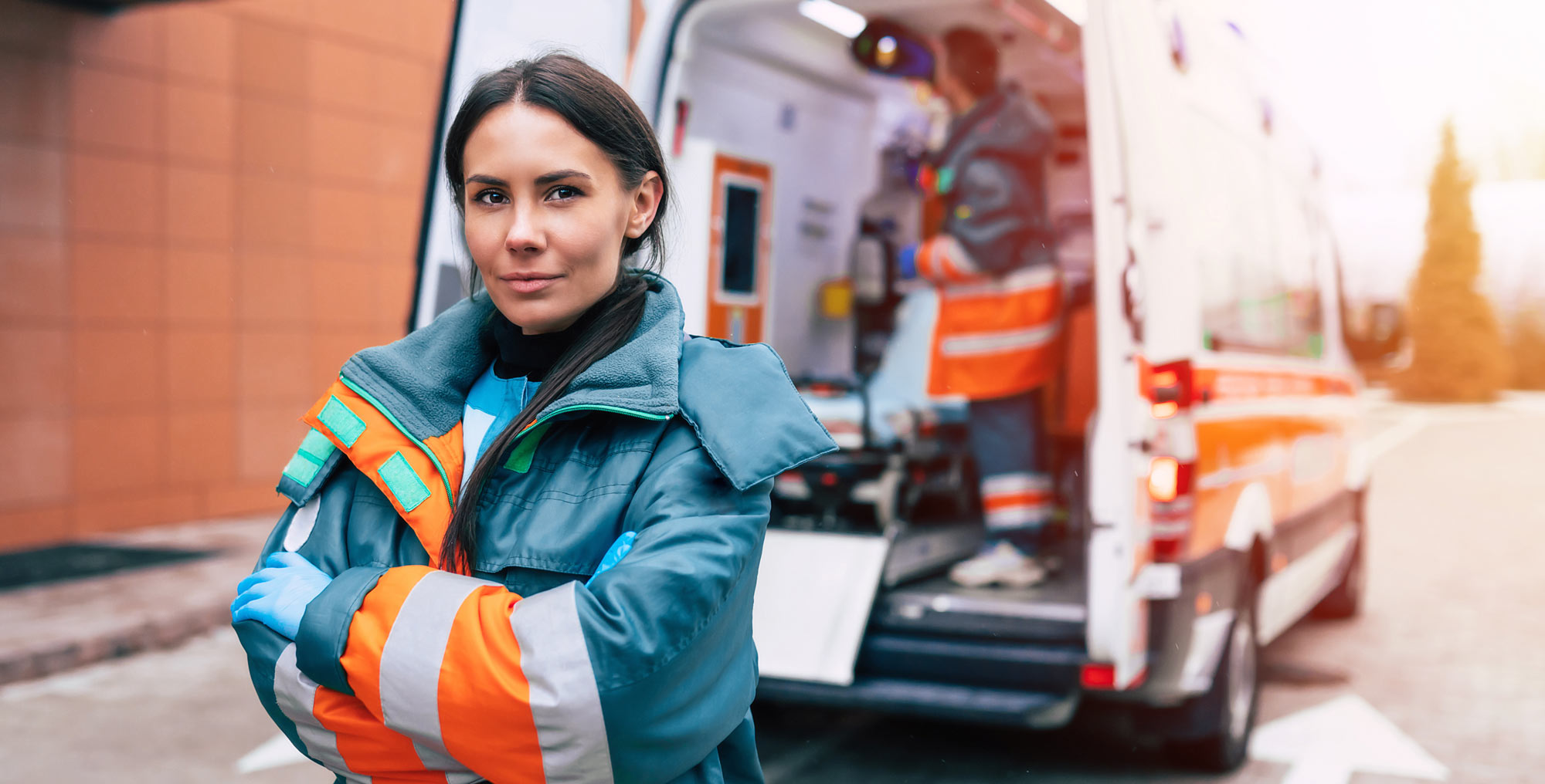 First responder standing in front of emergency vehicle